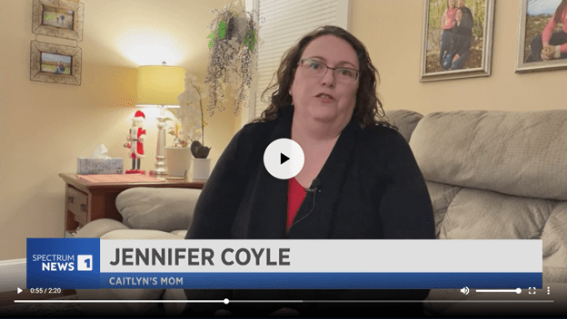 Woman sitting on couch, wearing glasses, with "Jennifer Coyle" text overlay, photo.